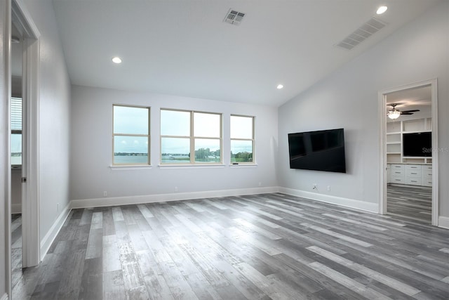 unfurnished living room featuring high vaulted ceiling, built in shelves, ceiling fan, and hardwood / wood-style floors