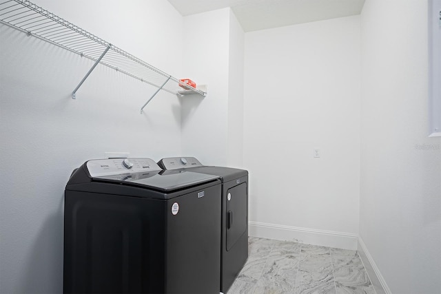 laundry area with washing machine and clothes dryer