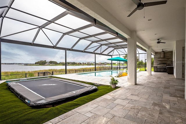 exterior space with a water view, a patio area, and a pool