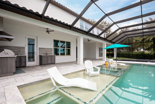 view of swimming pool with ceiling fan, sink, a lanai, and a patio area