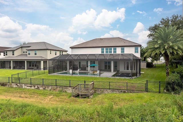 back of property featuring a lanai, a fenced in pool, a patio area, and a yard