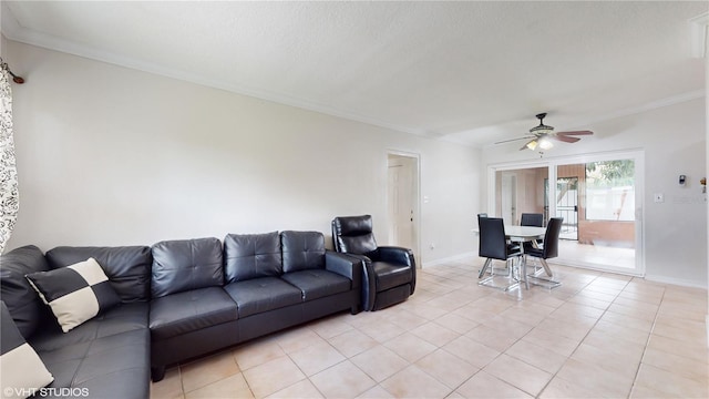 living room featuring light tile patterned flooring, ornamental molding, and ceiling fan