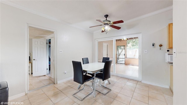 dining area with crown molding, light tile patterned floors, and ceiling fan