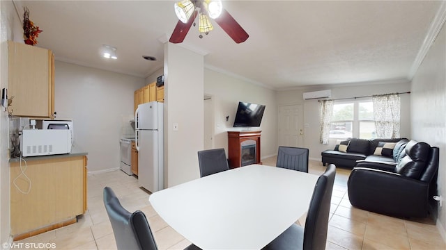 tiled dining space featuring ceiling fan, crown molding, and a wall mounted air conditioner