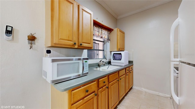 kitchen featuring white appliances, ornamental molding, sink, and light tile patterned floors