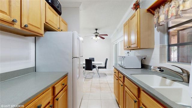 kitchen with white appliances, ceiling fan, tasteful backsplash, and sink