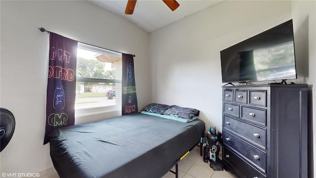 bedroom with light tile patterned floors, lofted ceiling, and ceiling fan