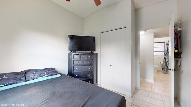 bedroom featuring ensuite bath, vaulted ceiling, ceiling fan, and light tile patterned floors