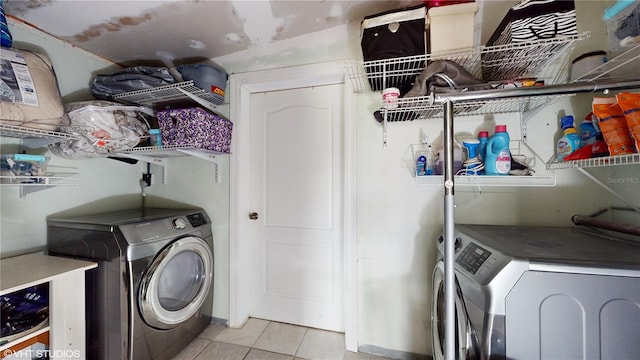 laundry room with light tile patterned flooring and separate washer and dryer