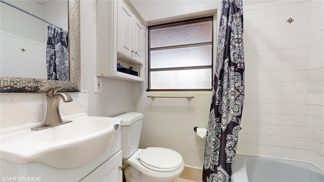 full bathroom featuring vanity, toilet, and shower / bathtub combination with curtain