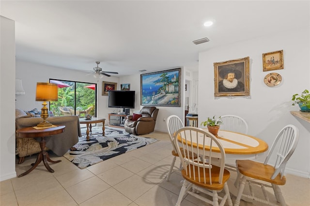 dining space featuring ceiling fan and light tile patterned floors