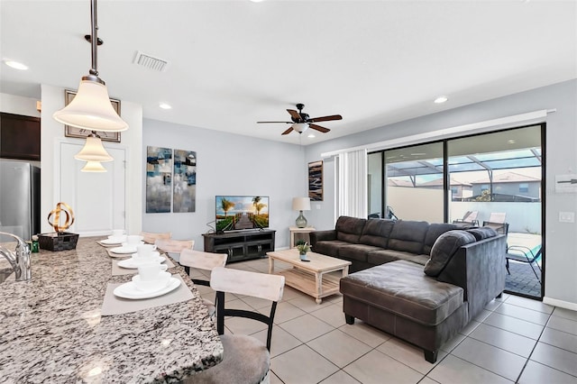 living room with ceiling fan and light tile patterned floors