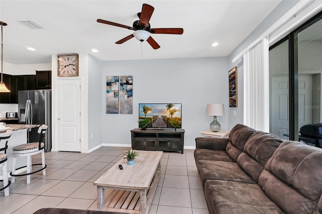 tiled living room featuring ceiling fan