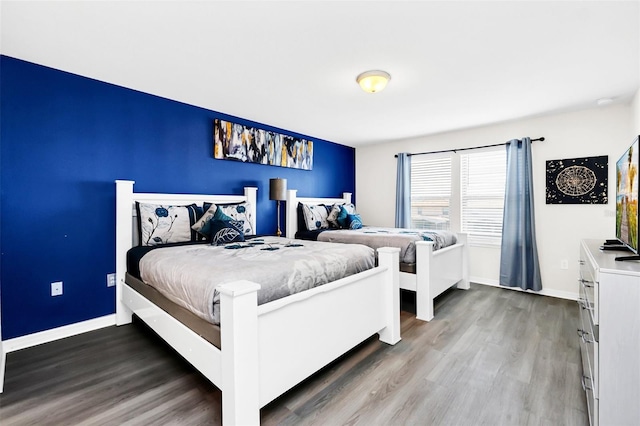 bedroom with dark wood-type flooring