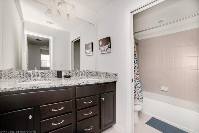 full bathroom with tile patterned floors, shower / bath combo, toilet, and vanity