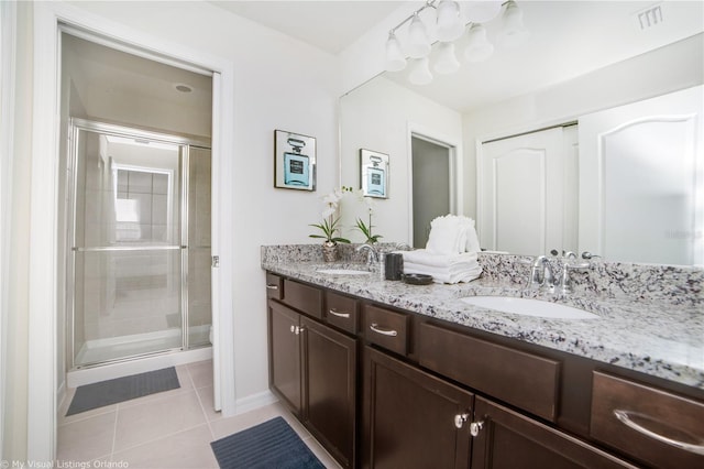 bathroom featuring vanity, walk in shower, and tile patterned floors