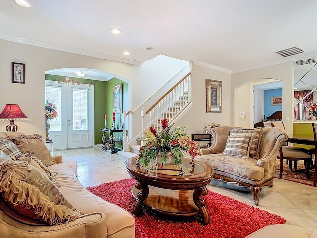 tiled living room with ornamental molding and french doors