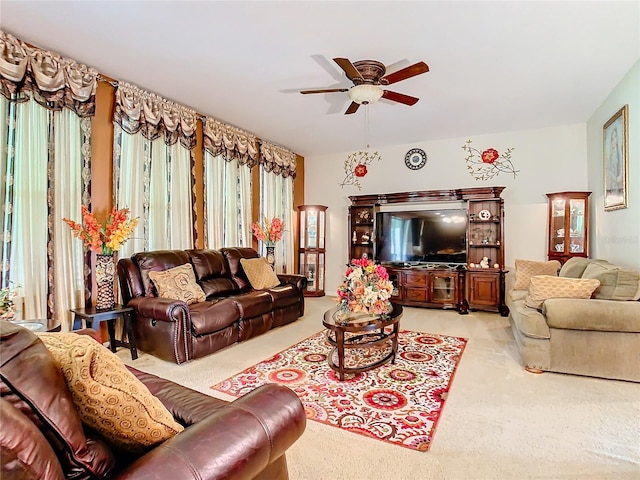 living room featuring light carpet and ceiling fan