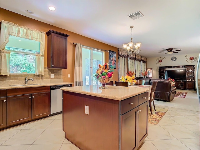 kitchen with ceiling fan with notable chandelier, dishwasher, sink, and a wealth of natural light