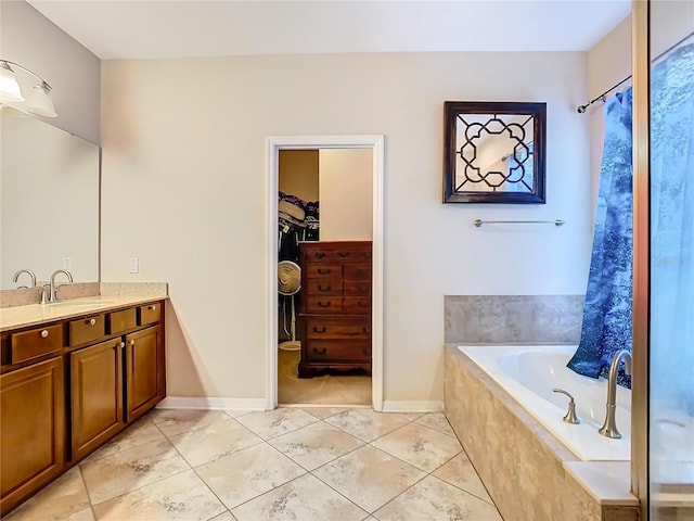 bathroom with tile patterned flooring, independent shower and bath, and vanity