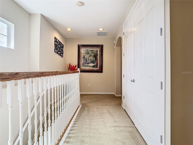 corridor with light colored carpet