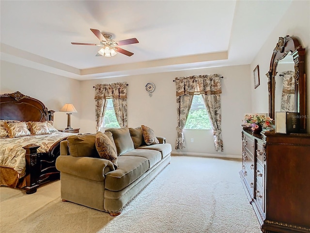 bedroom with ceiling fan, light carpet, and multiple windows