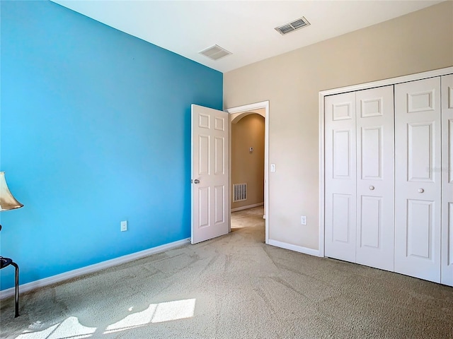 unfurnished bedroom with carpet floors and a closet