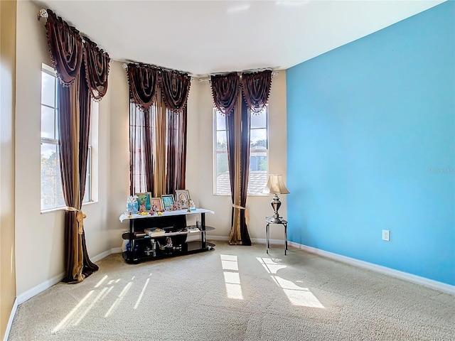 carpeted spare room featuring a wealth of natural light