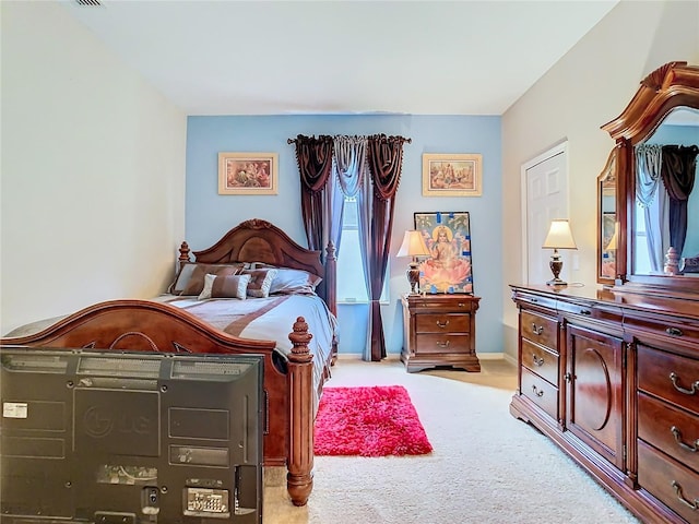 bedroom featuring light carpet