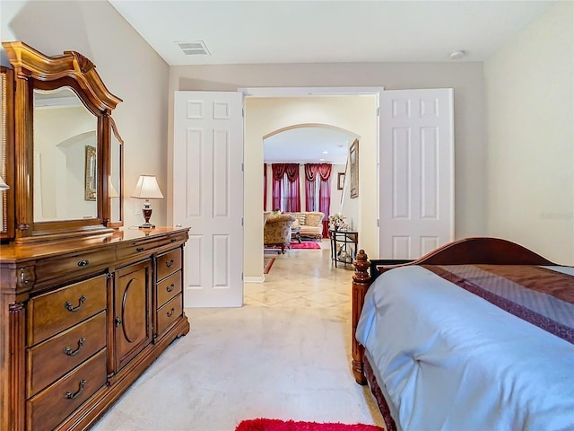 bedroom featuring light colored carpet and a closet