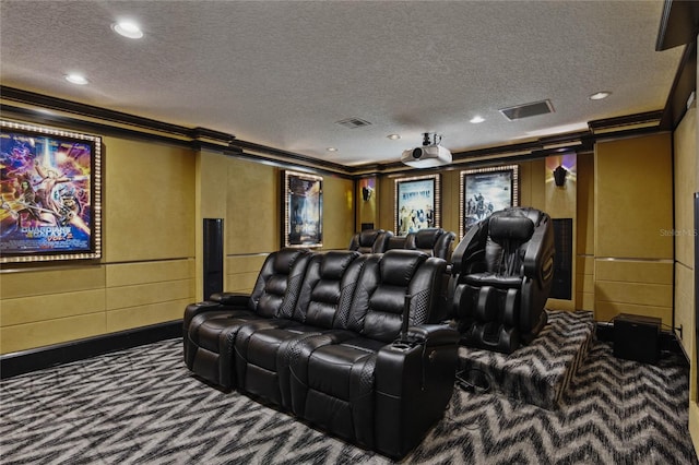 home theater with a textured ceiling, carpet floors, and crown molding