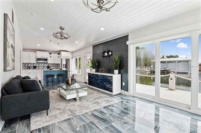 living room with wooden ceiling, lofted ceiling, and a notable chandelier