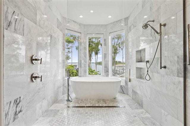 bathroom featuring plenty of natural light, shower with separate bathtub, and tile walls