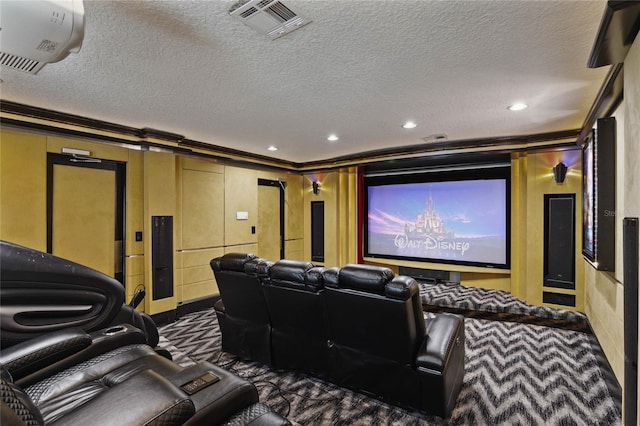 carpeted home theater with a textured ceiling and crown molding