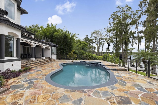 view of pool featuring an in ground hot tub and a patio