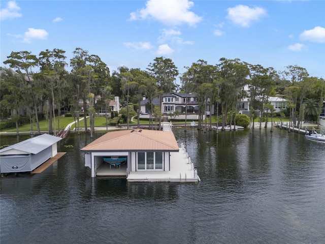 dock area with boat lift, a residential view, and a water view