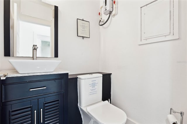 bathroom with electric panel, toilet, and vanity