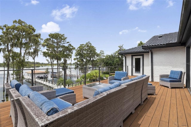 wooden deck featuring outdoor lounge area and a water view