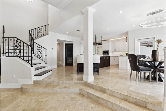 entrance foyer featuring recessed lighting, decorative columns, baseboards, and stairs