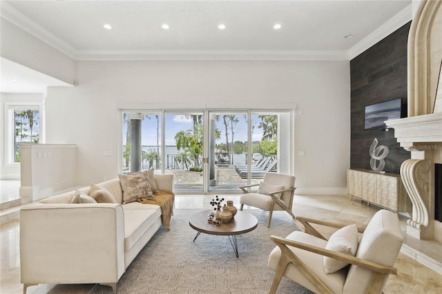 living room with a wealth of natural light, recessed lighting, ornamental molding, and a premium fireplace