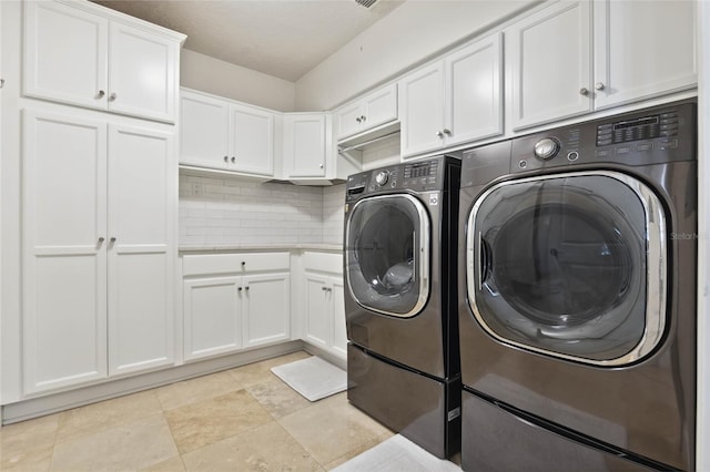 laundry room featuring cabinet space and separate washer and dryer