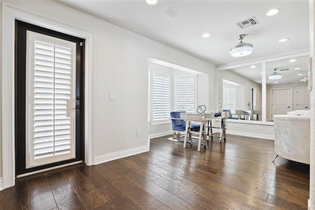 dining space with dark wood-style floors, visible vents, recessed lighting, and baseboards