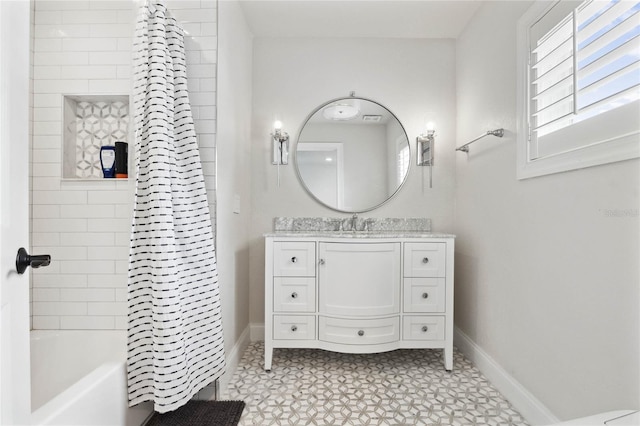 full bathroom with baseboards, shower / bath combo, and vanity