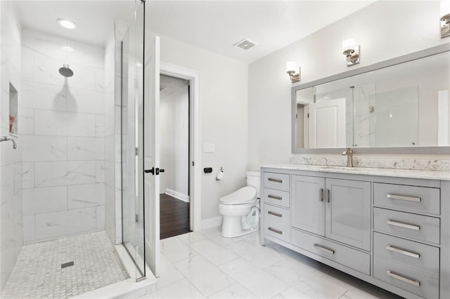 full bathroom featuring visible vents, toilet, marble finish floor, a marble finish shower, and vanity