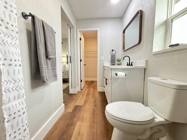 bathroom featuring vanity, toilet, and hardwood / wood-style flooring