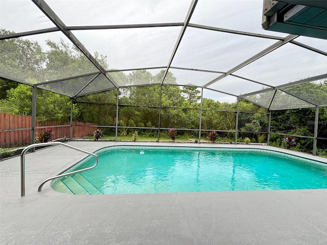 view of swimming pool with a lanai and a patio area