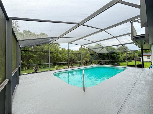 view of swimming pool with a lanai and a patio area