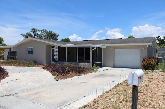 single story home featuring stucco siding, driveway, an attached garage, and a sunroom