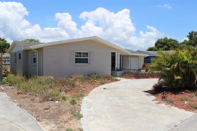 view of front of home featuring a garage, driveway, and stucco siding