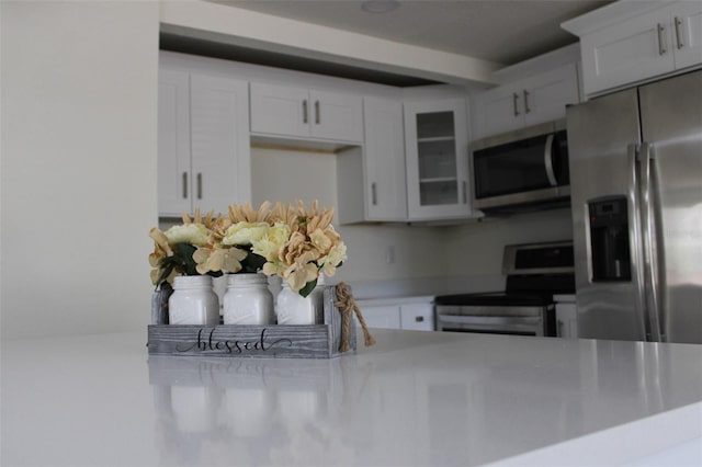 kitchen featuring appliances with stainless steel finishes and white cabinetry